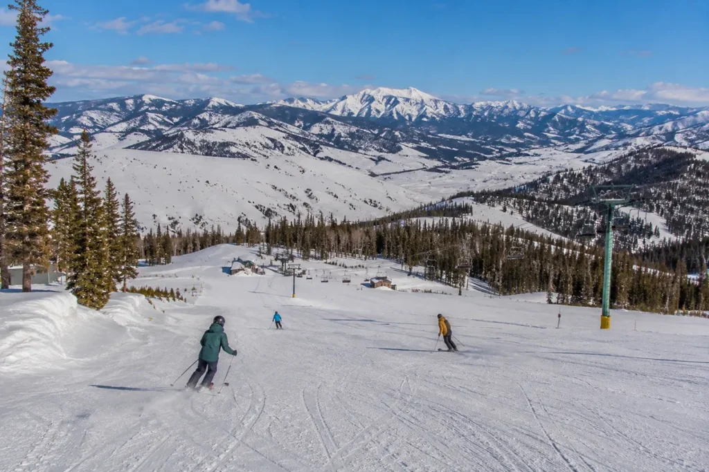 Discovery Ski Area outside Butte Montana with skiers on uncrowded runs and mountain peaks in background