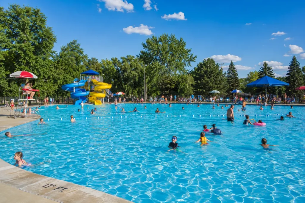 Families enjoying the Mitchell Pool at Electric City Water Park on a sunny summer day in Great Falls Montana