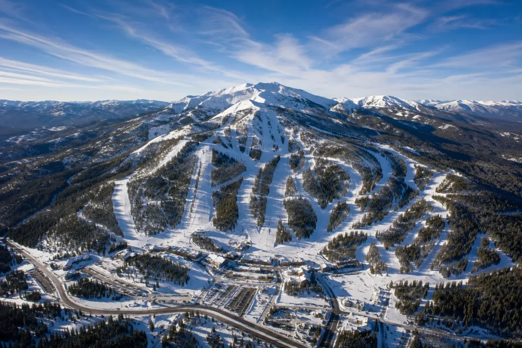 Aerial view of Montana ski resort with multiple chairlifts visible across a wide mountain valley on a sunny winter day