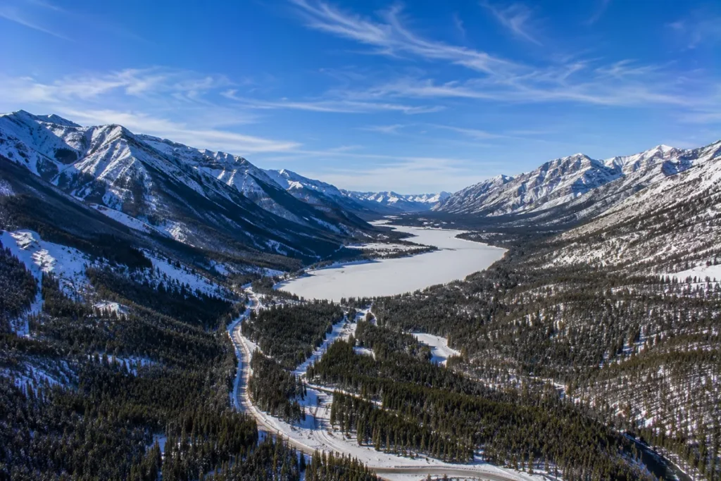 Aerial view of the Flint Creek Valley with the mountains around Discovery Ski Area visible and Georgetown Lake in the foreground frozen and snow-covered