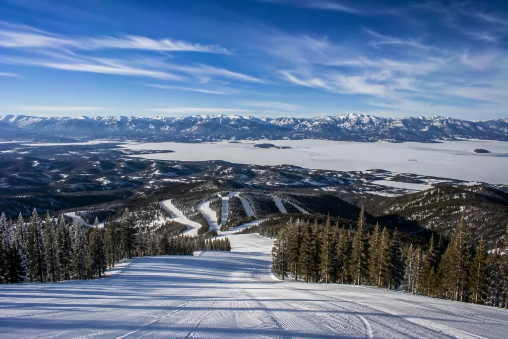 View from the top of Discovery Ski Area looking down across the front-face runs toward Georgetown Lake and the Anaconda-Pintler Wilderness in the distance
