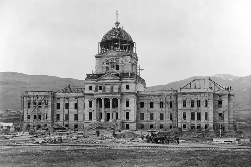 Historic black and white photograph of the Montana State Capitol during construction in early 1900s