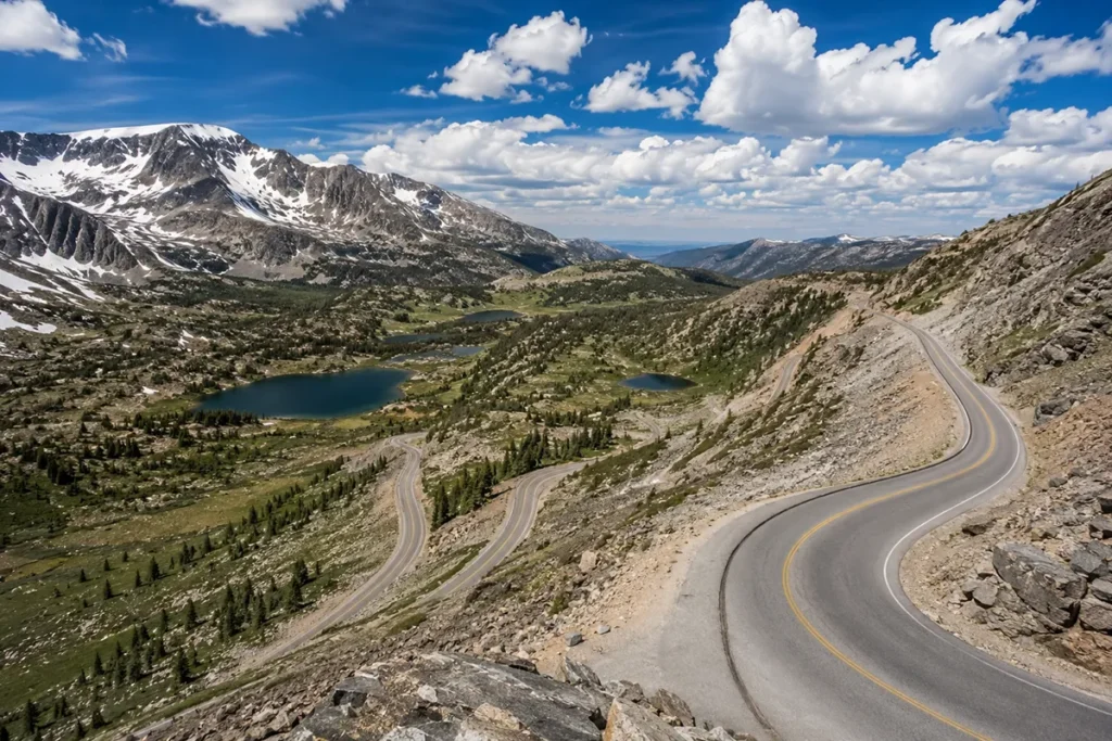 Beartooth Highway switchbacks in summer with snow-capped peaks and alpine lakes, US-212 Montana