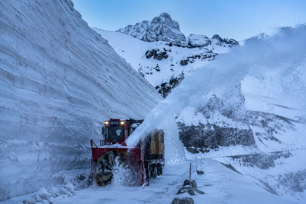 Rotary snowplow clearing massive snowdrifts on Going-to-the-Sun Road in spring
