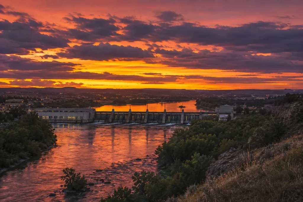 Sunset over the Missouri River in Great Falls Montana with hydroelectric dam silhouette