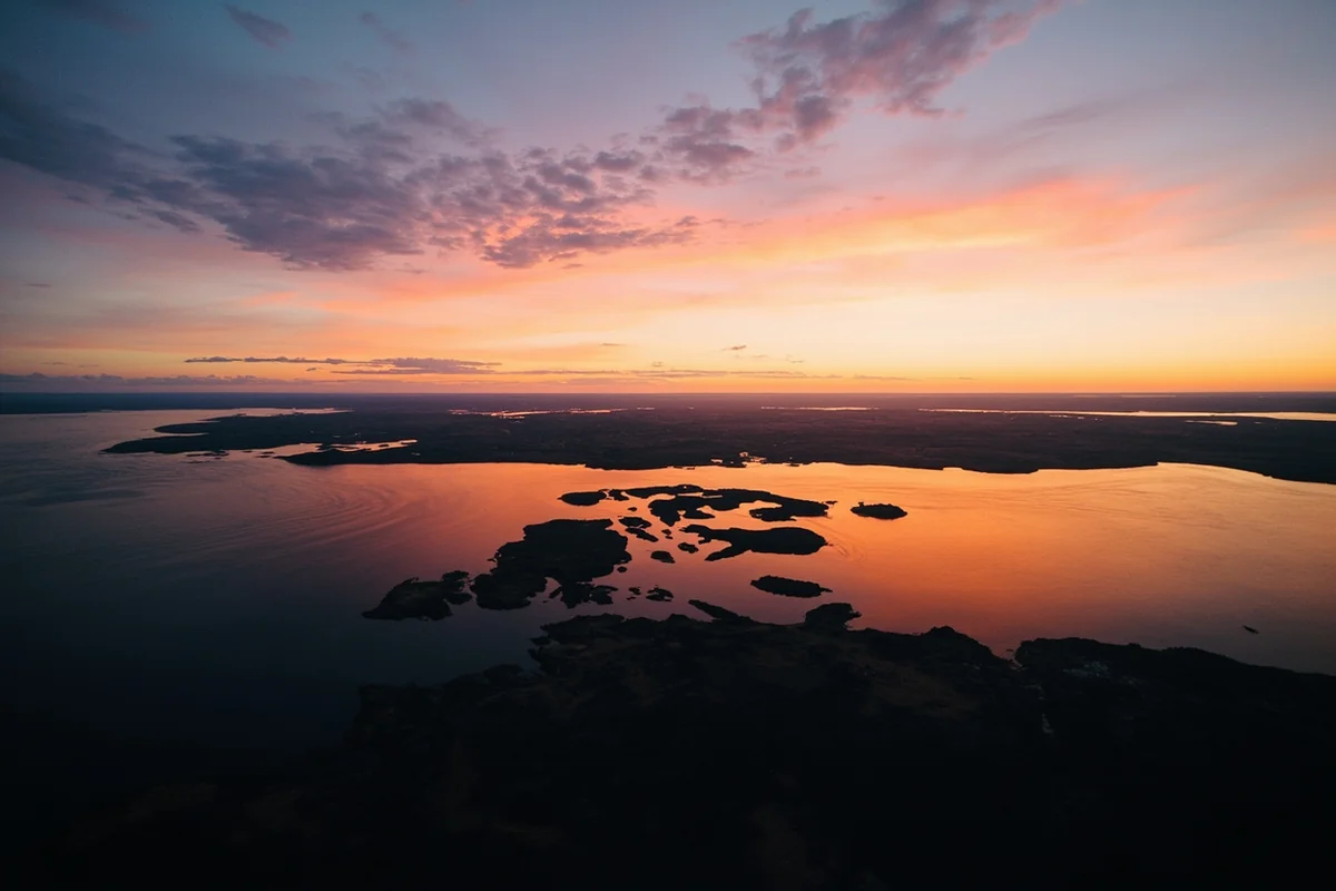 Aerial view of Fort Peck Lake at sunset showing the vast reservoir where towns once stood