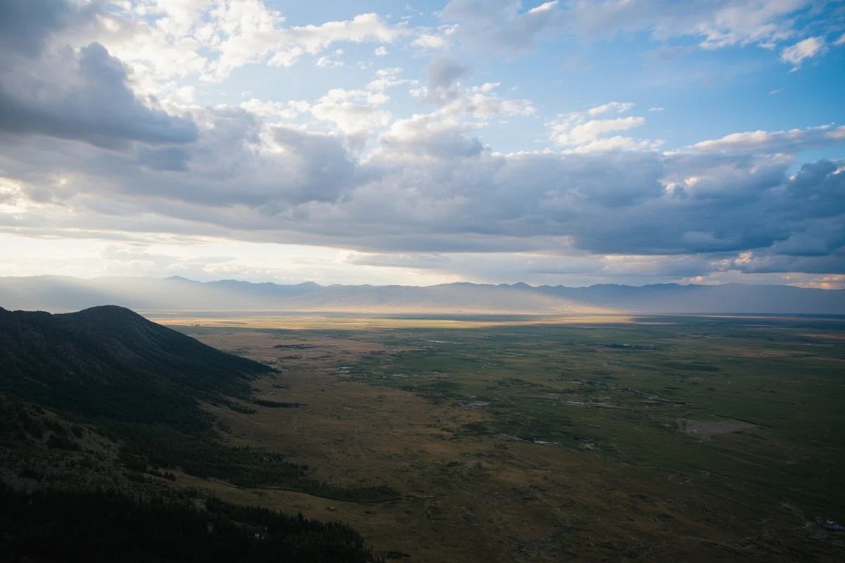 Aerial view of Montana landscape showing mountains meeting plains with dramatic sky