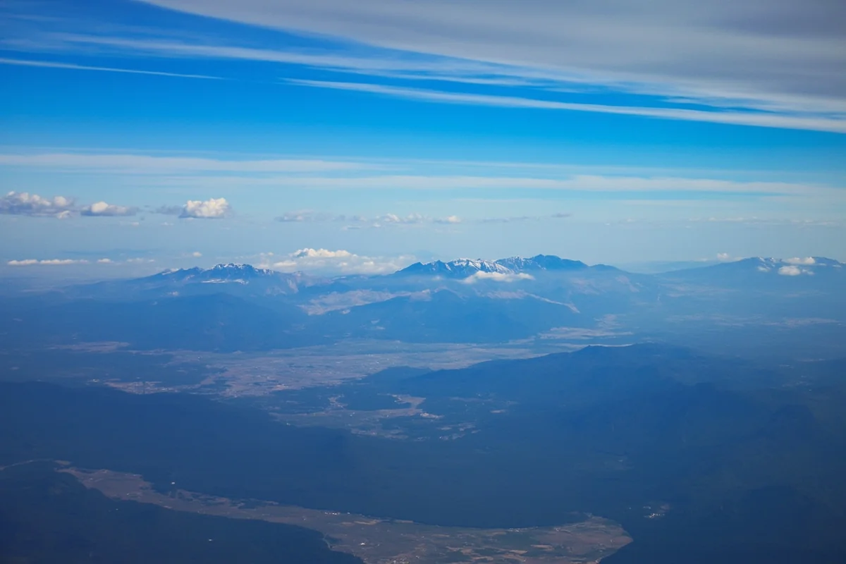 Aerial view of Montana landscape showing mountains meeting plains, taken from airplane window
