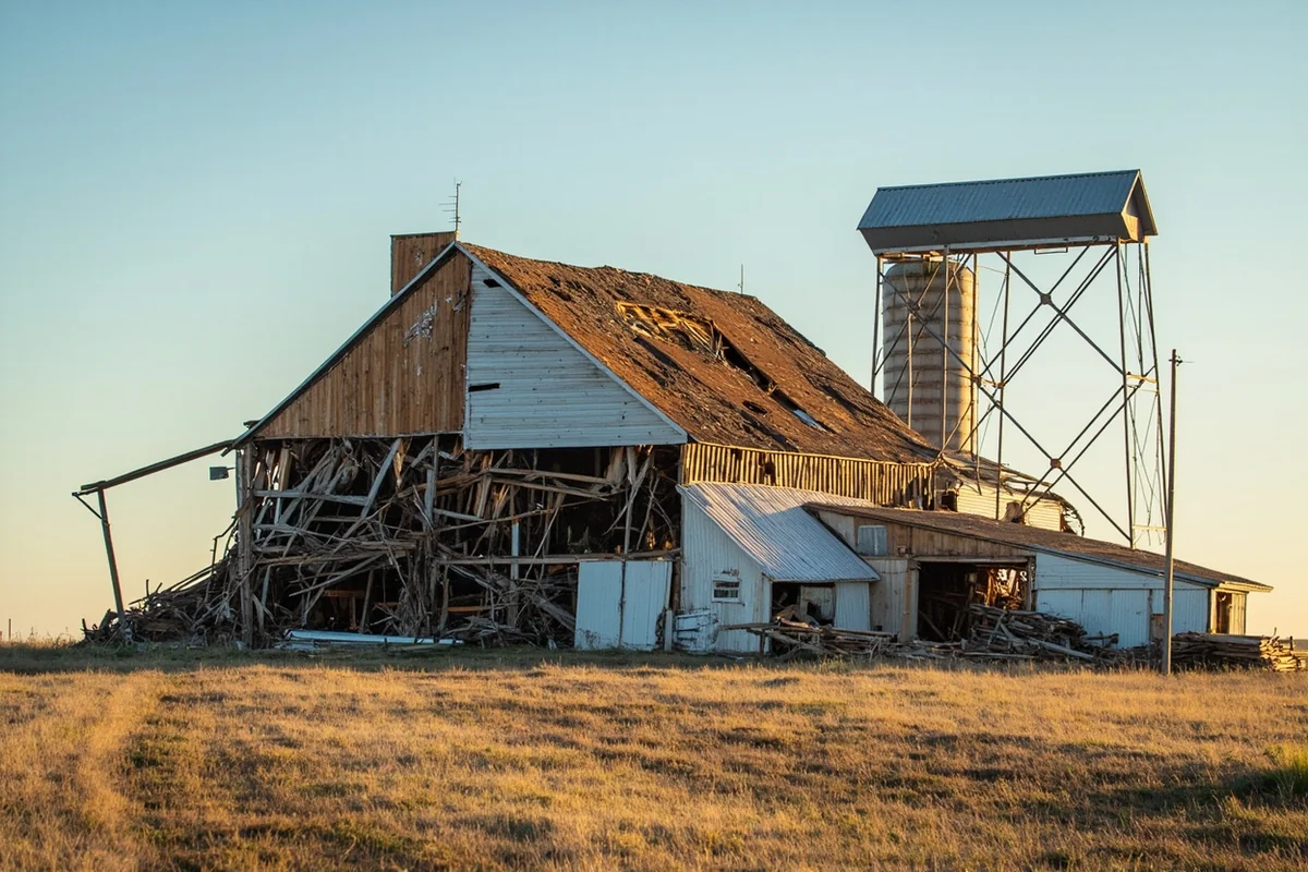 Aftermath photo of tornado damage to a rural Montana farm building or grain silo