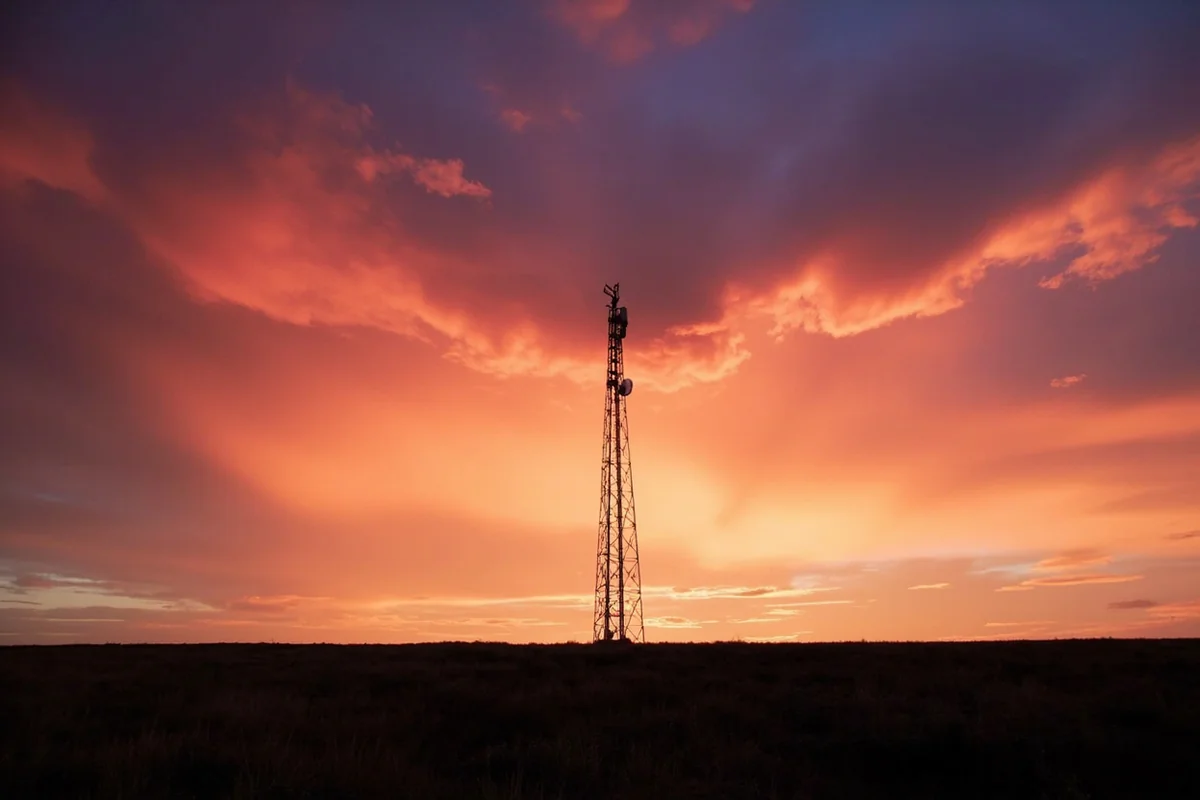 Cell tower against dramatic Montana sunset sky near Bozeman