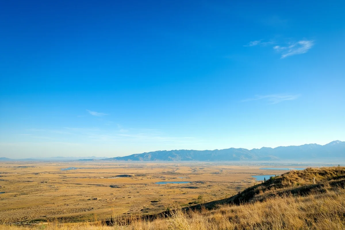 Clear blue sky over a Montana valley in summer, showing the typical dry, low-humidity conditions