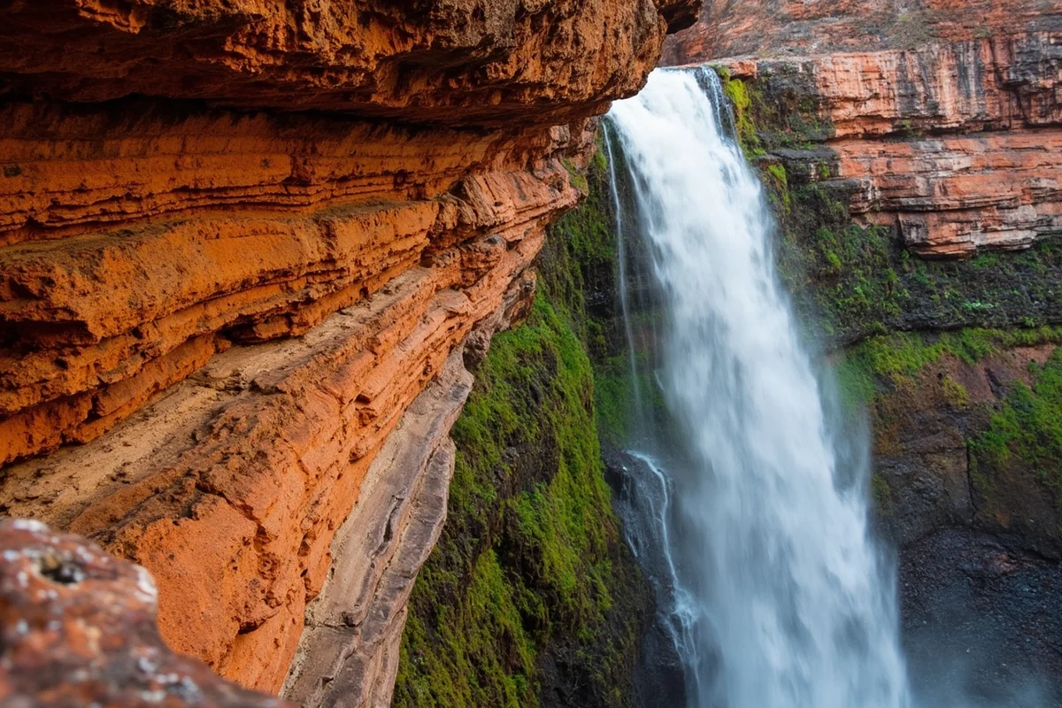 Close-up of layered rock formations beside Paradise Falls showing colorful striations