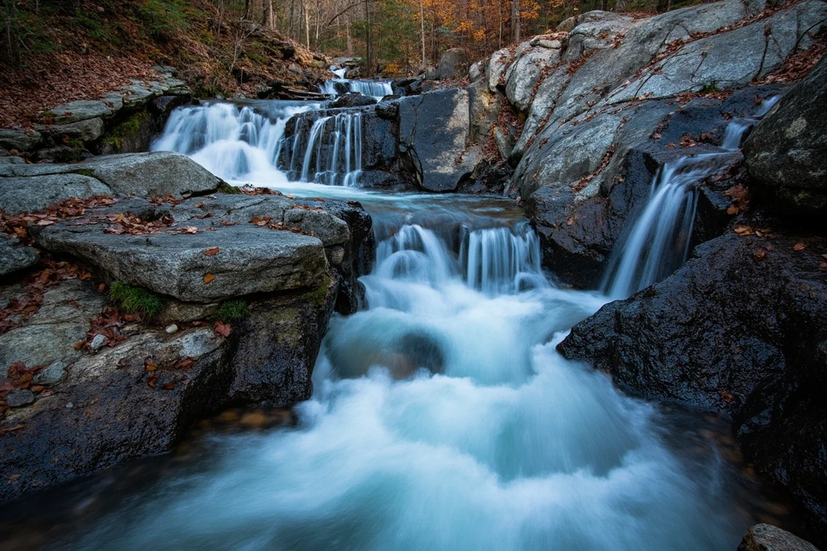 Close-up of Lost Creek Falls showing the multi-tiered cascade over granite rocks