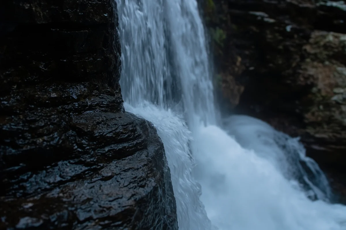 Close-up of Ousel Falls water pattern showing horsetail formation against dark rock face