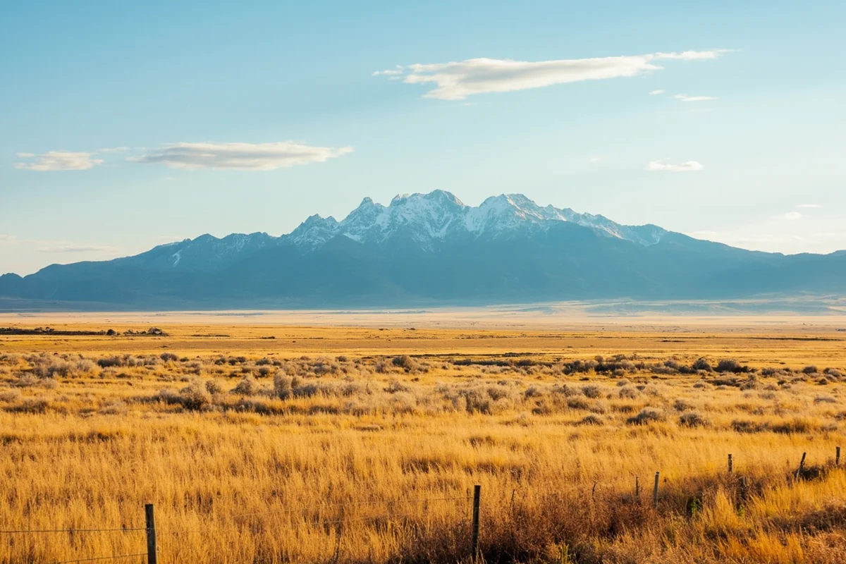 Contrast shot showing Montana prairies with distant mountain peaks