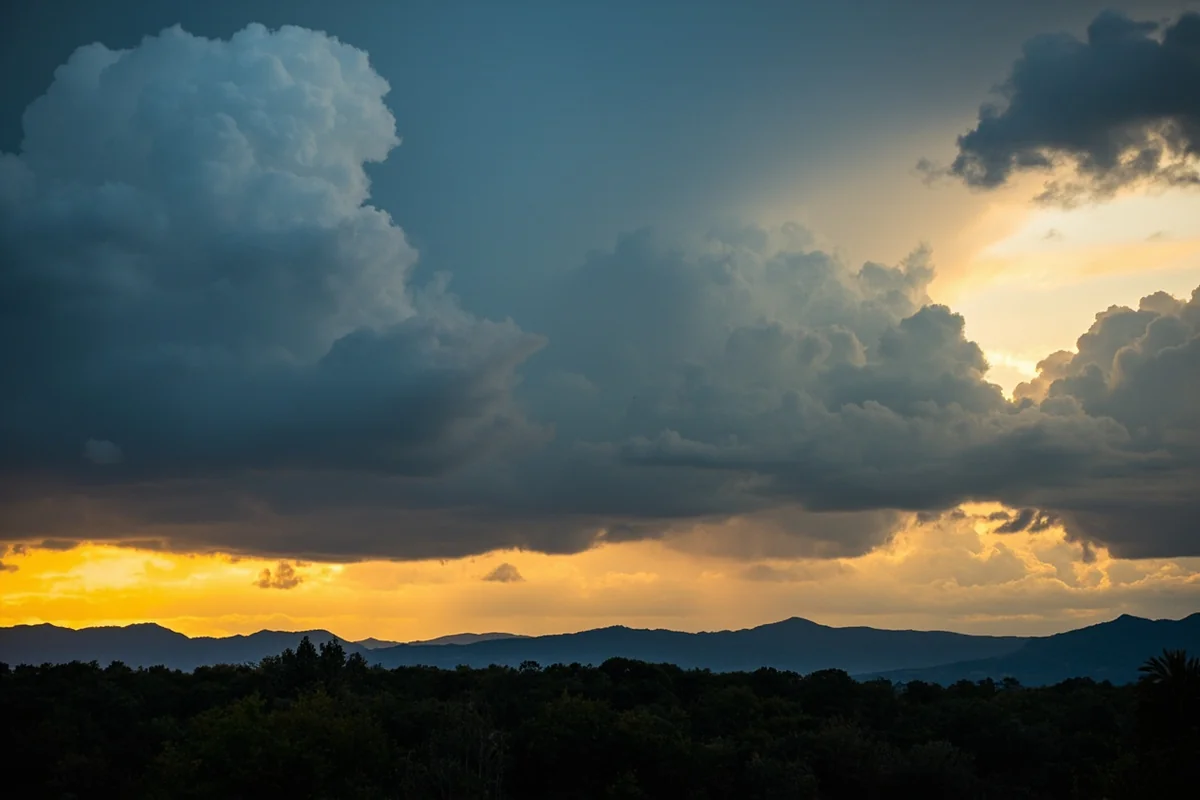 Dramatic afternoon thunderstorm clouds building over the Mission Mountains with golden light breaking through