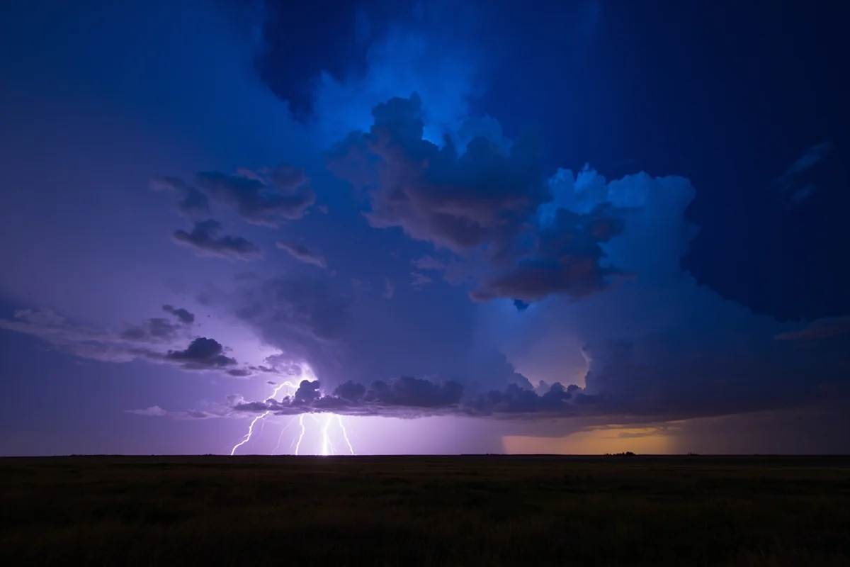 Dramatic lightning strike over Montana prairie during summer thunderstorm at dusk