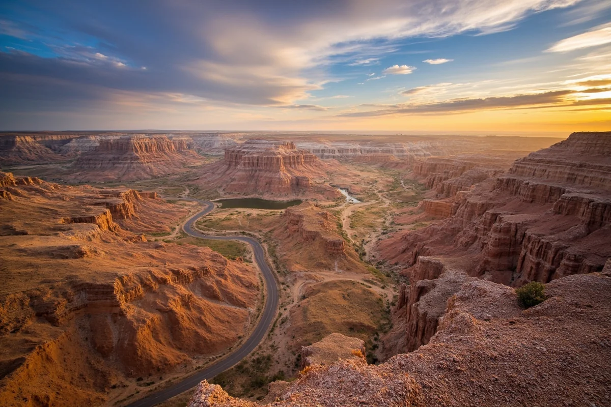 Dramatic Missouri Breaks badlands landscape with winding road visible cutting through eroded formations