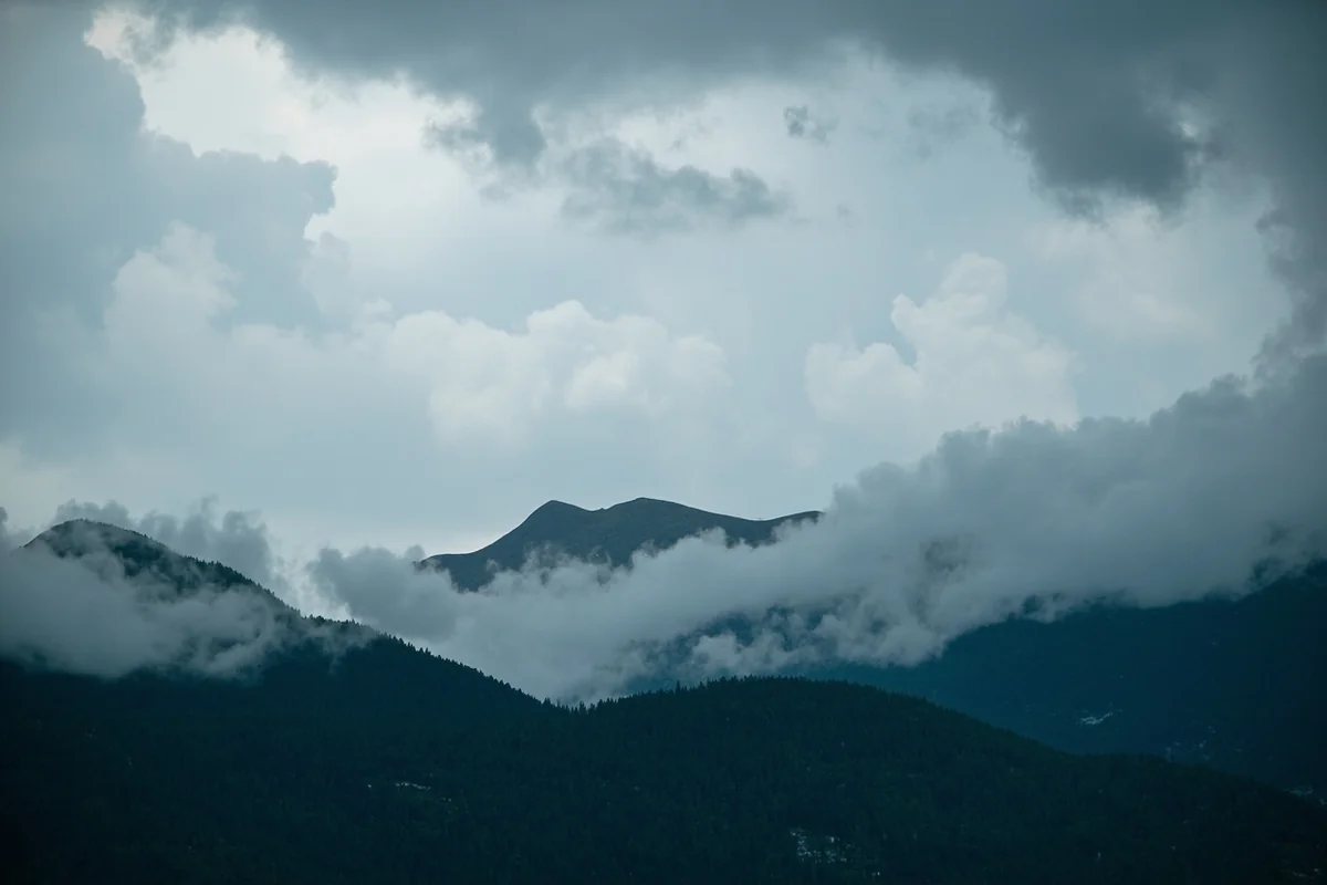 Dramatic Montana sky with storm clouds rolling over mountain peaks near Glacier National Park