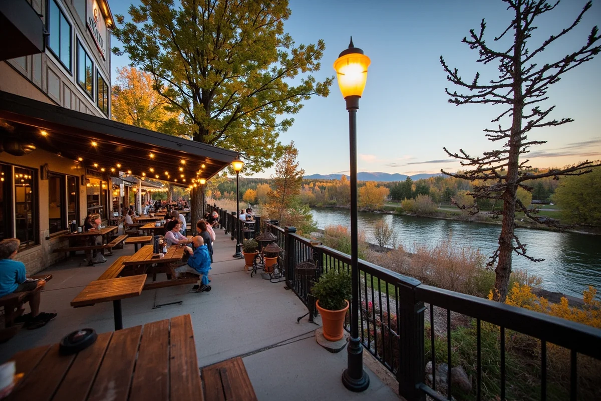 Draught Works patio with Clark Fork River visible and patrons enjoying beer at picnic tables