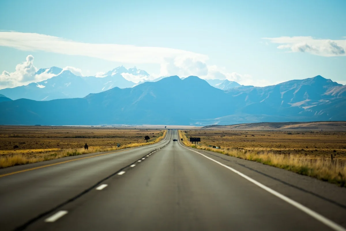 Empty scenic highway through Montana with mountains in distance