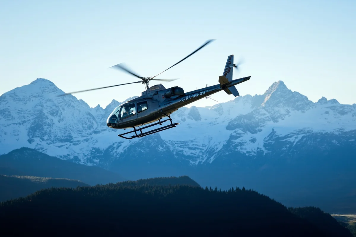 Helicopter flying over Glacier National Park with snow-capped peaks in background