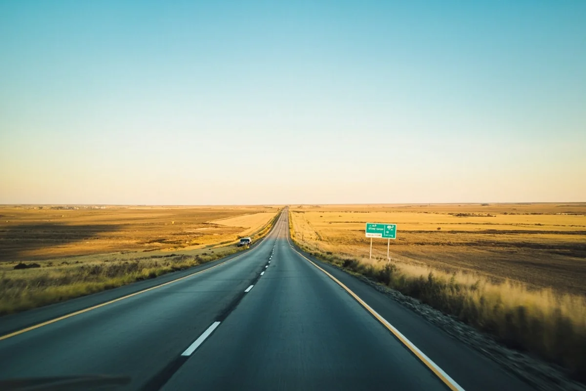 Highway 2 stretching toward the Canadian border with vast prairie landscape