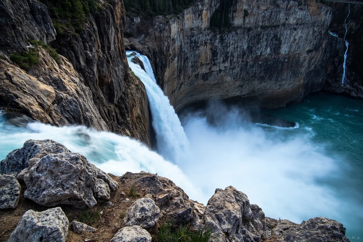 Knowles Falls cascading into the Yellowstone River with dark canyon walls in background