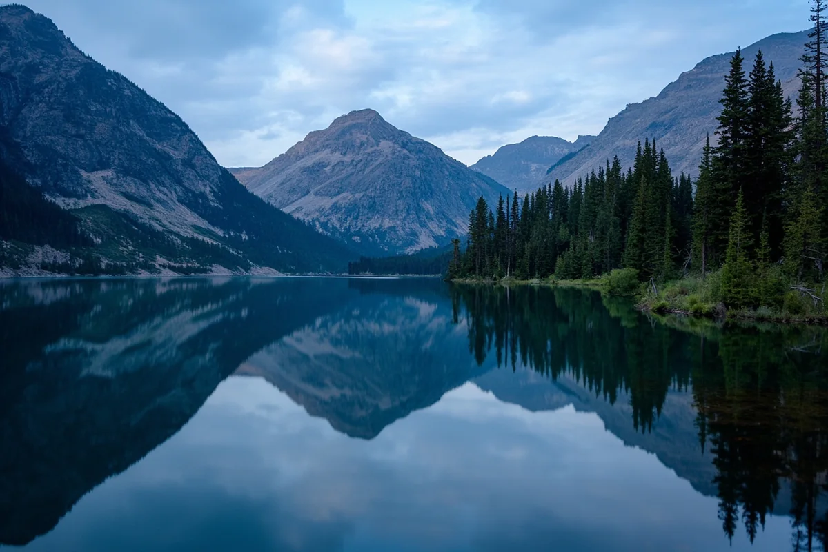 Lake McDonald with mountain reflection showing area near Horsetail Falls trailhead