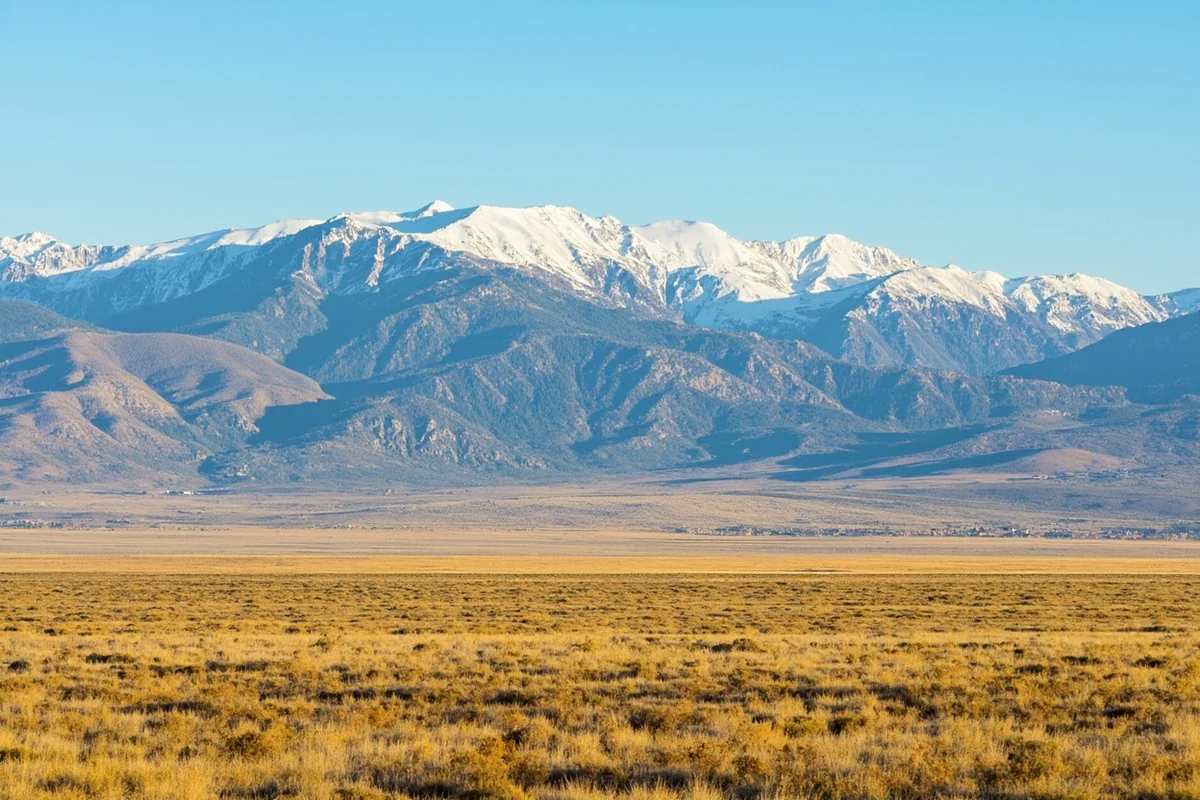 Landscape comparison showing Eastern Montana's vast prairies alongside Western Montana's dramatic mountain ranges