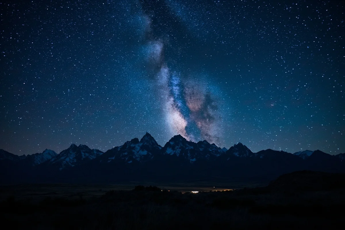 Milky Way stretching over a silhouetted mountain range in Montana
