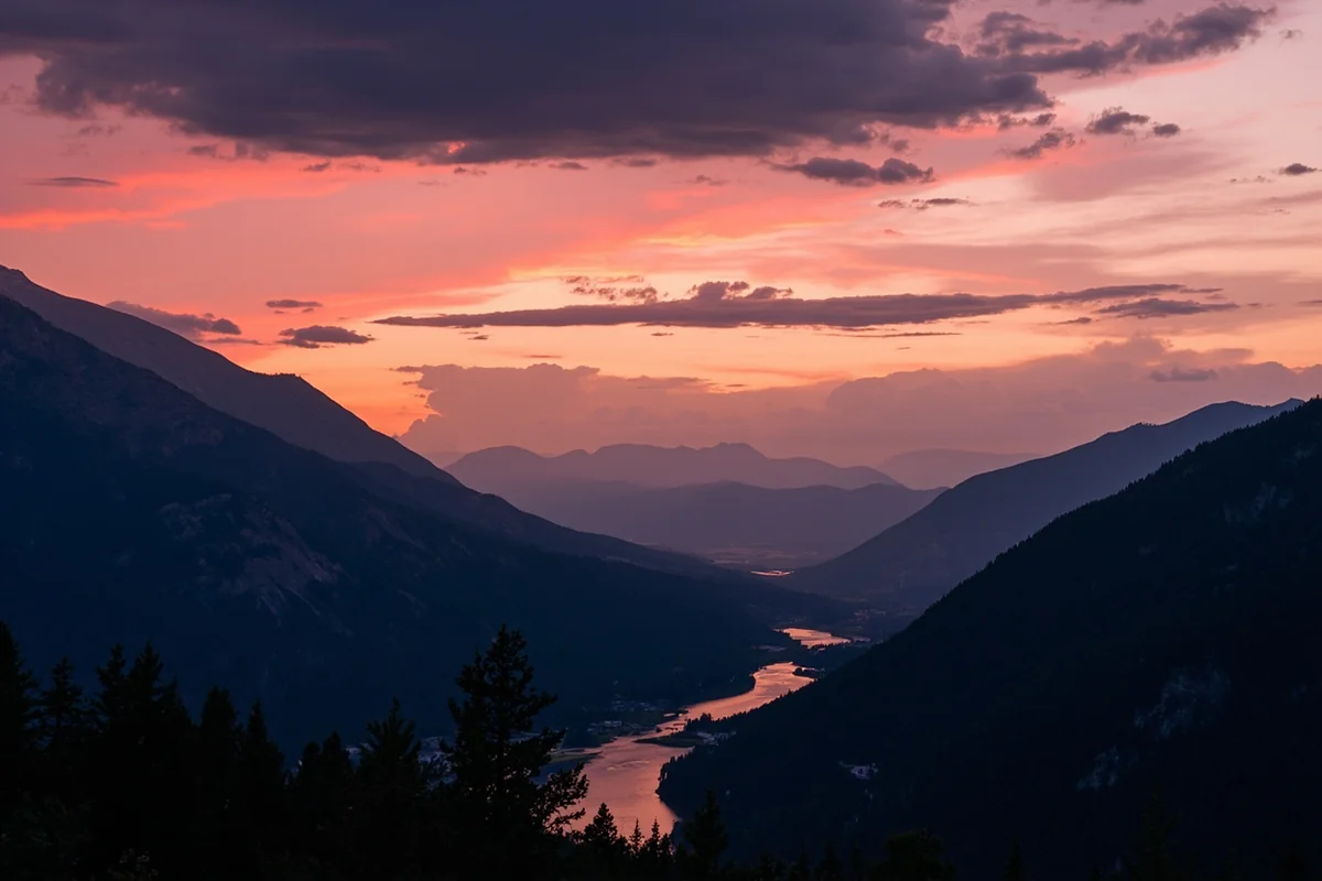 Montana sunset over mountain valley with winding river and dramatic cloud formations