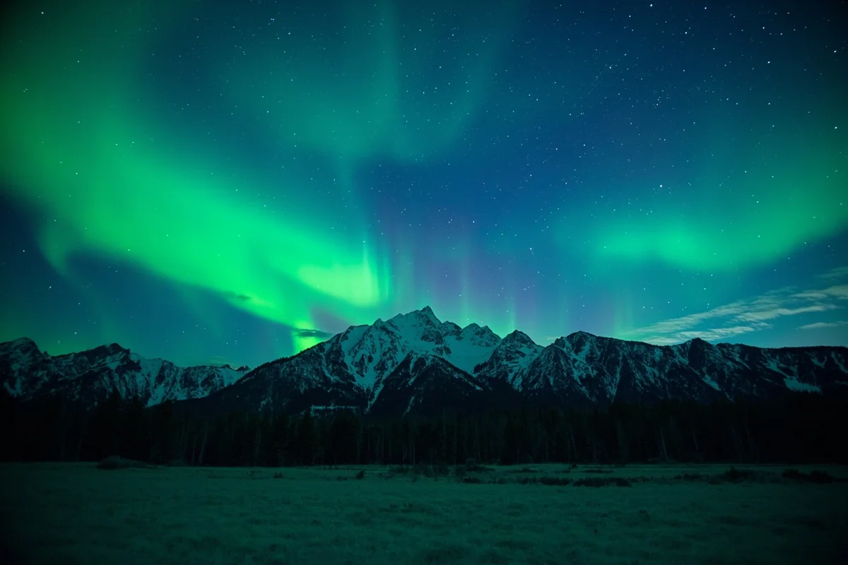 Northern lights visible over Montana mountain landscape