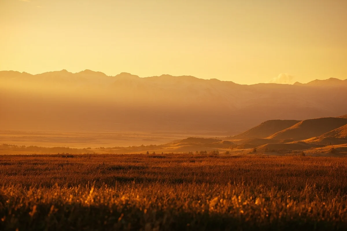 Panoramic landscape of Montana wildlife refuge at golden hour with mountains in background