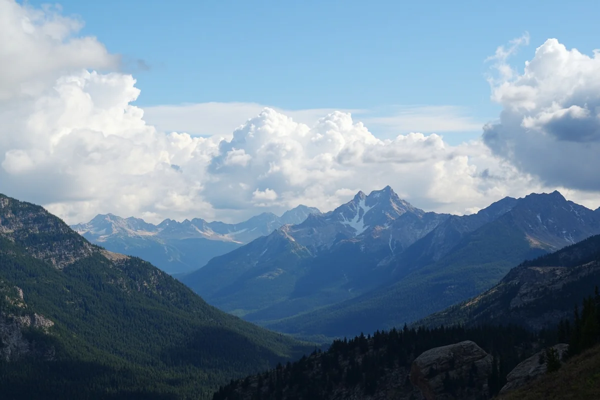 Panoramic view from Logan Pass showing the Continental Divide with dramatic clouds rolling over mountain peaks