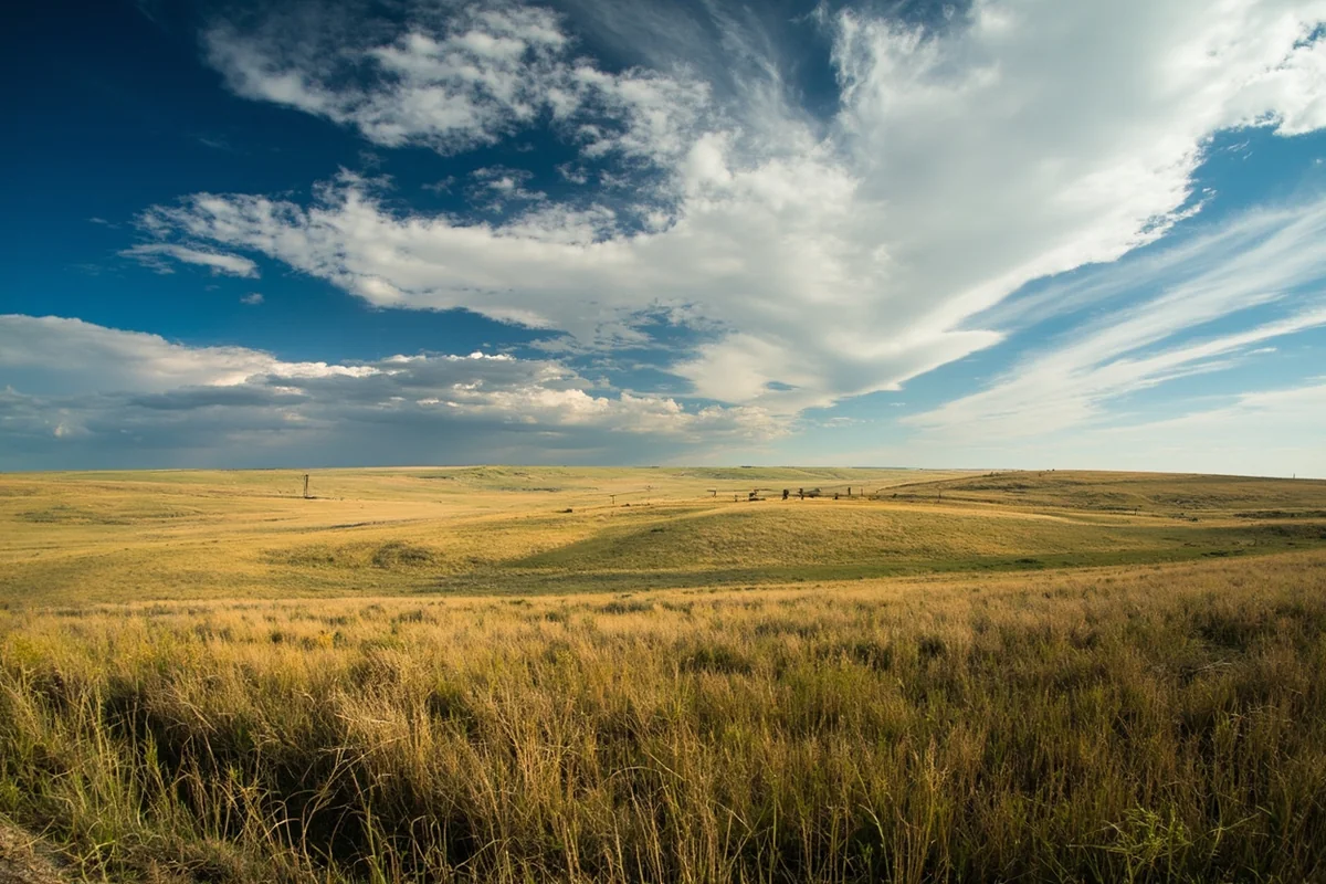 Panoramic view of eastern Montana prairie with endless grasslands and dramatic sky near Lewistown