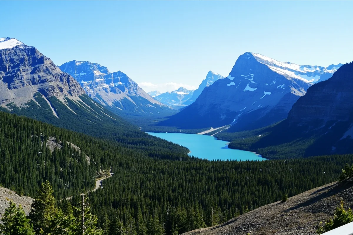 Panoramic view of Glacier National Park's mountain peaks with glacial lakes below, taken from Going-to-the-Sun Road