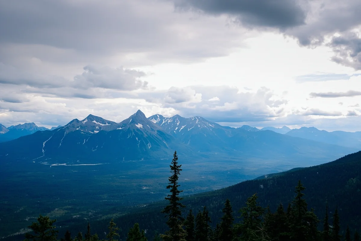 Panoramic view of Glacier National Park's mountain peaks with dramatic sky