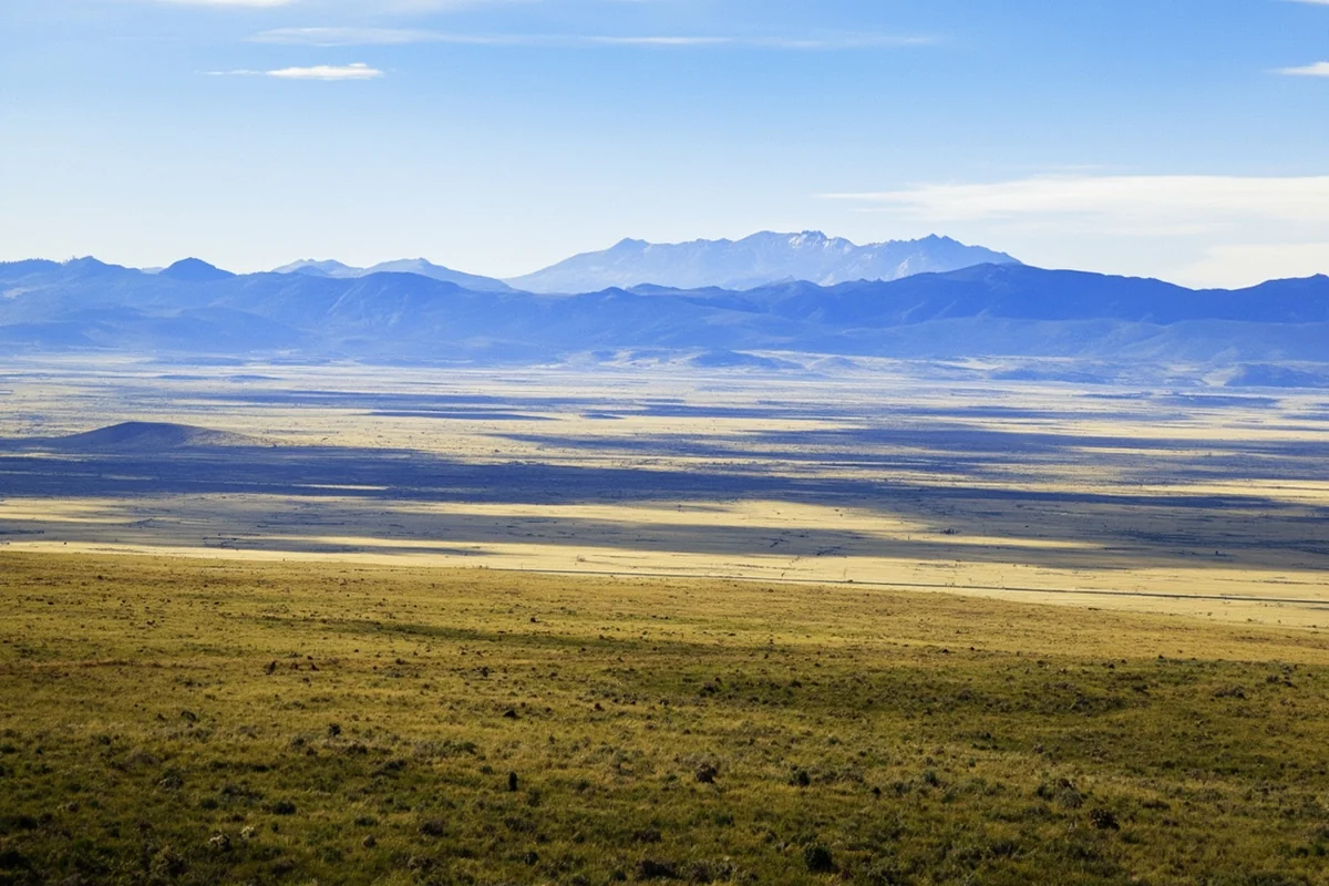 Panoramic view of Montana's diverse landscape showing mountains transitioning to prairie