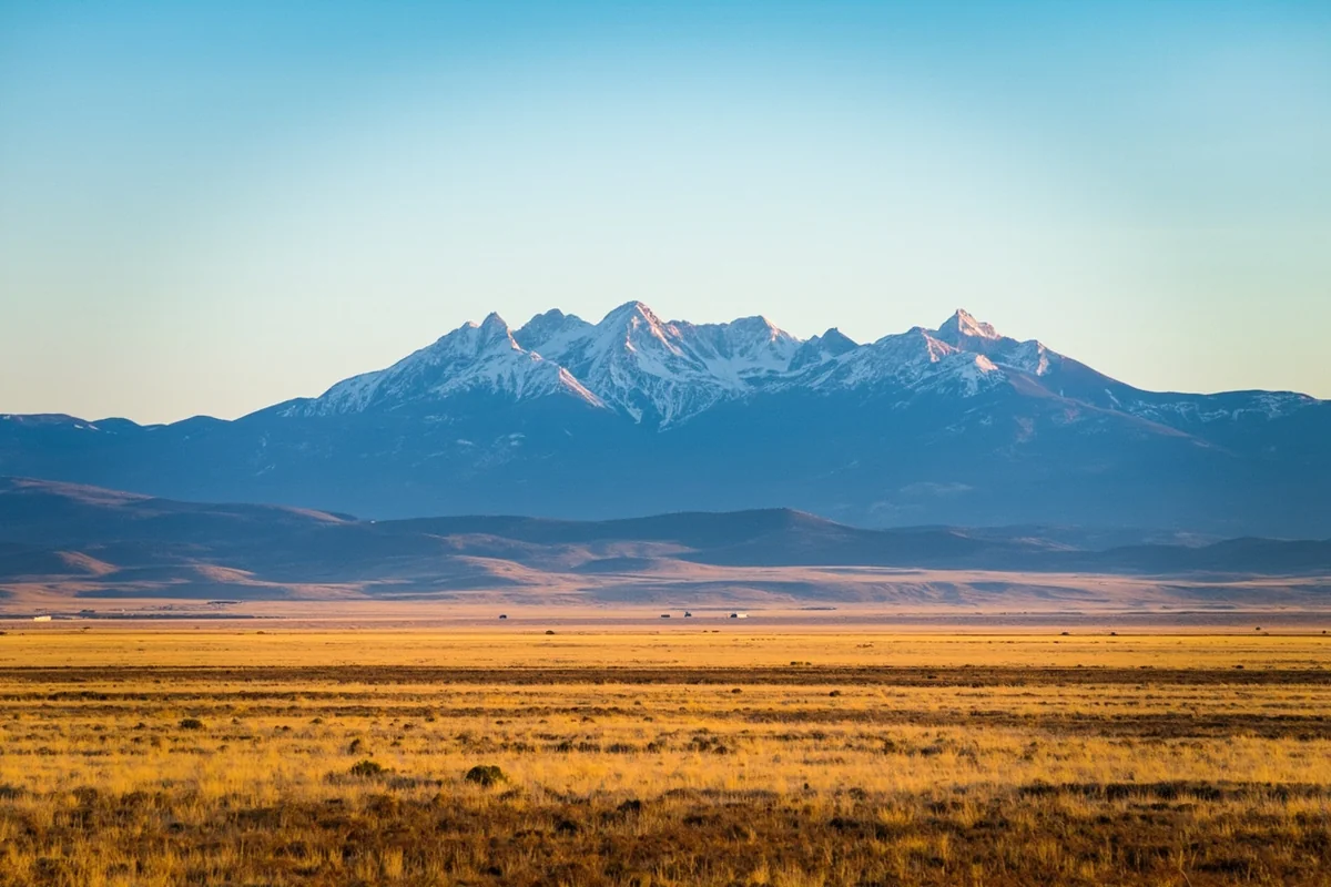 Panoramic view of Montana's diverse landscape showing mountains transitioning to prairie