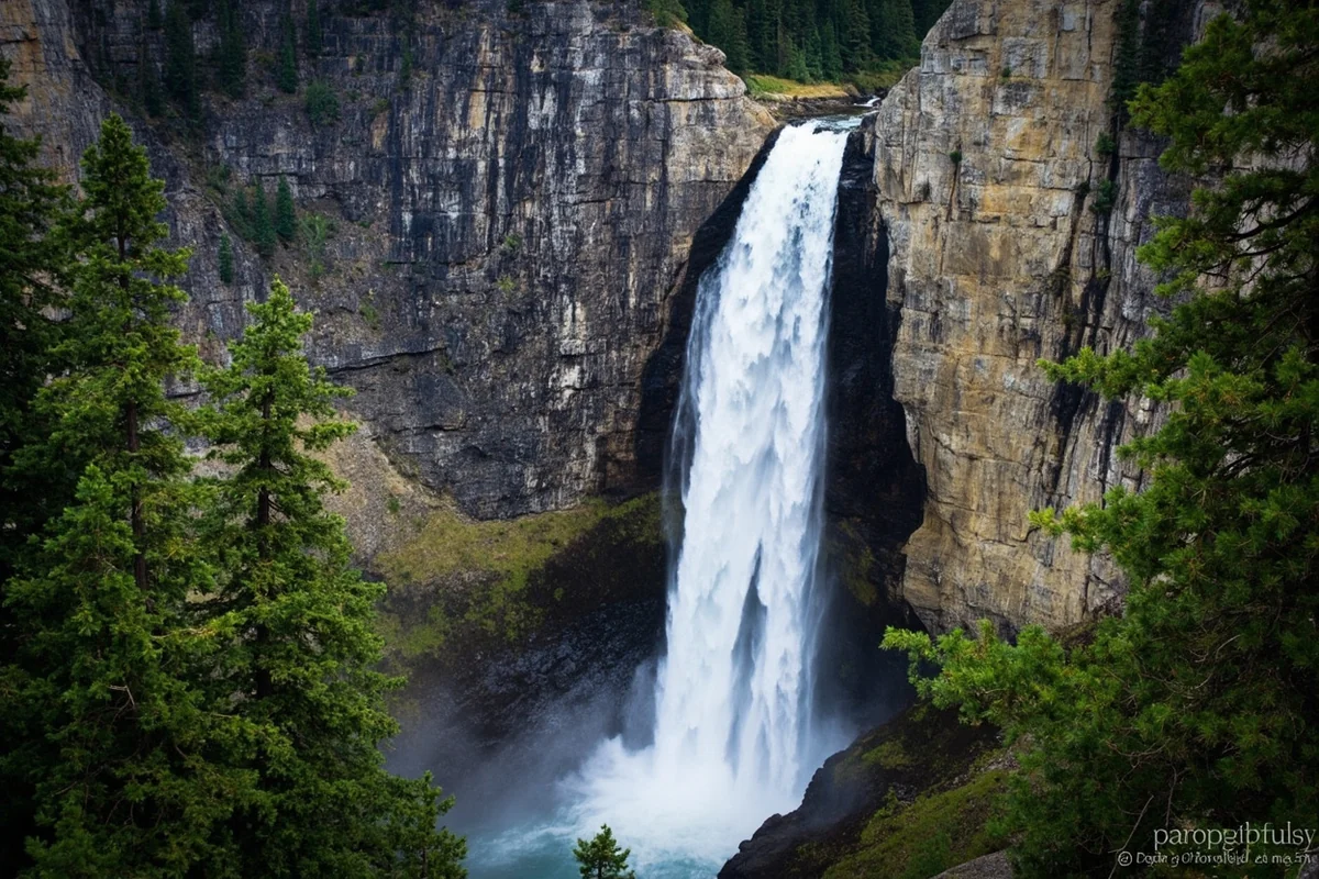 Rockwell Falls cascading down rocky cliff face with evergreen trees framing the view
