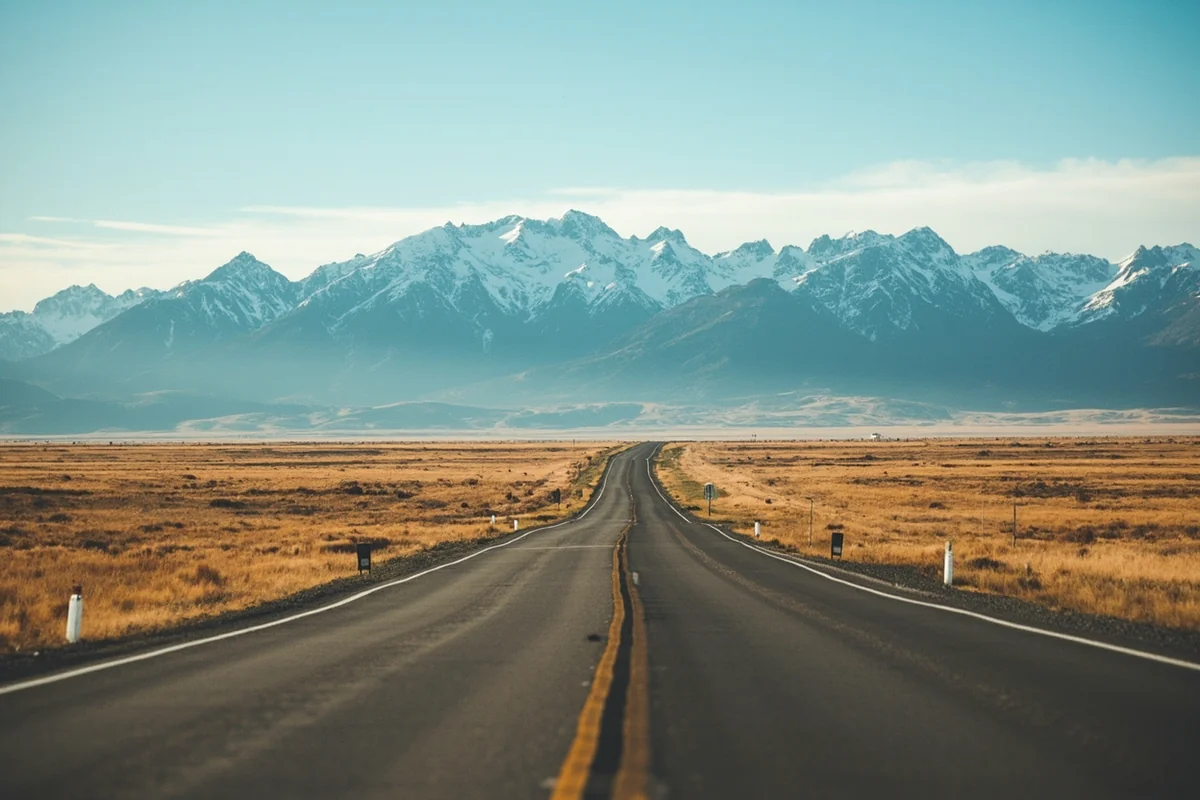 Rural Montana highway stretching toward distant mountains with no visible services