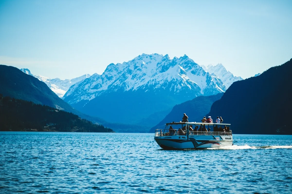 St. Mary Lake boat tour with dramatic mountain peaks rising in background