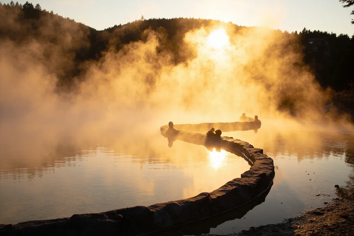 Steam rising from outdoor pool at Wild Horse Hot Springs during golden hour