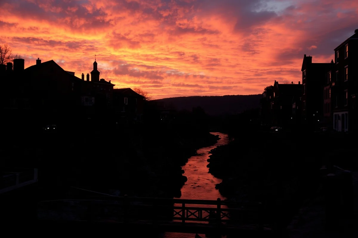 Sunset over Alder Gulch from Virginia City with historic buildings silhouetted