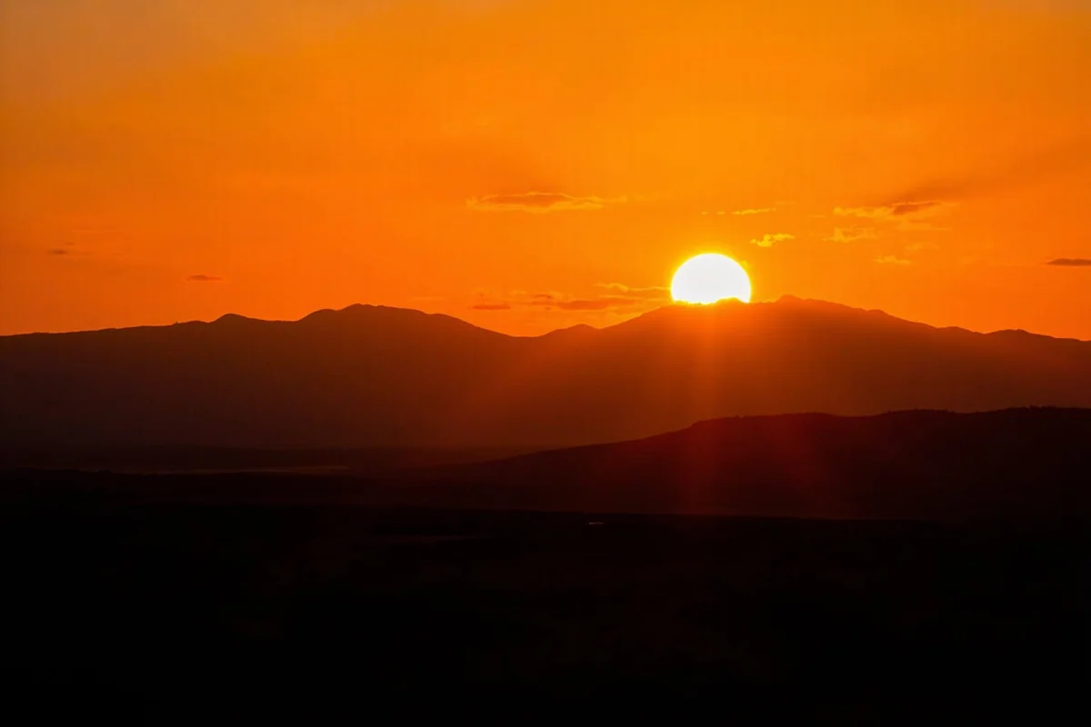 Sunset over Beaverhead Valley with mountains silhouetted against orange sky