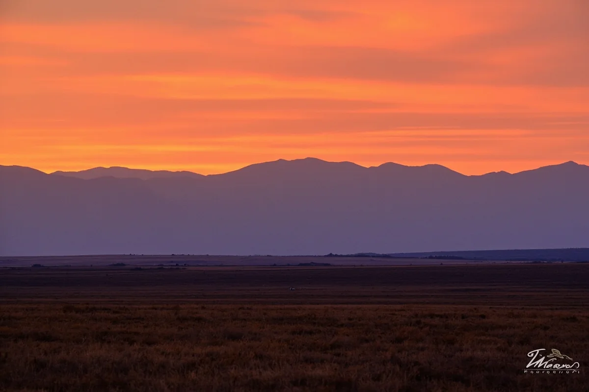 Sunset over Montana landscape showing transition from mountains to prairie
