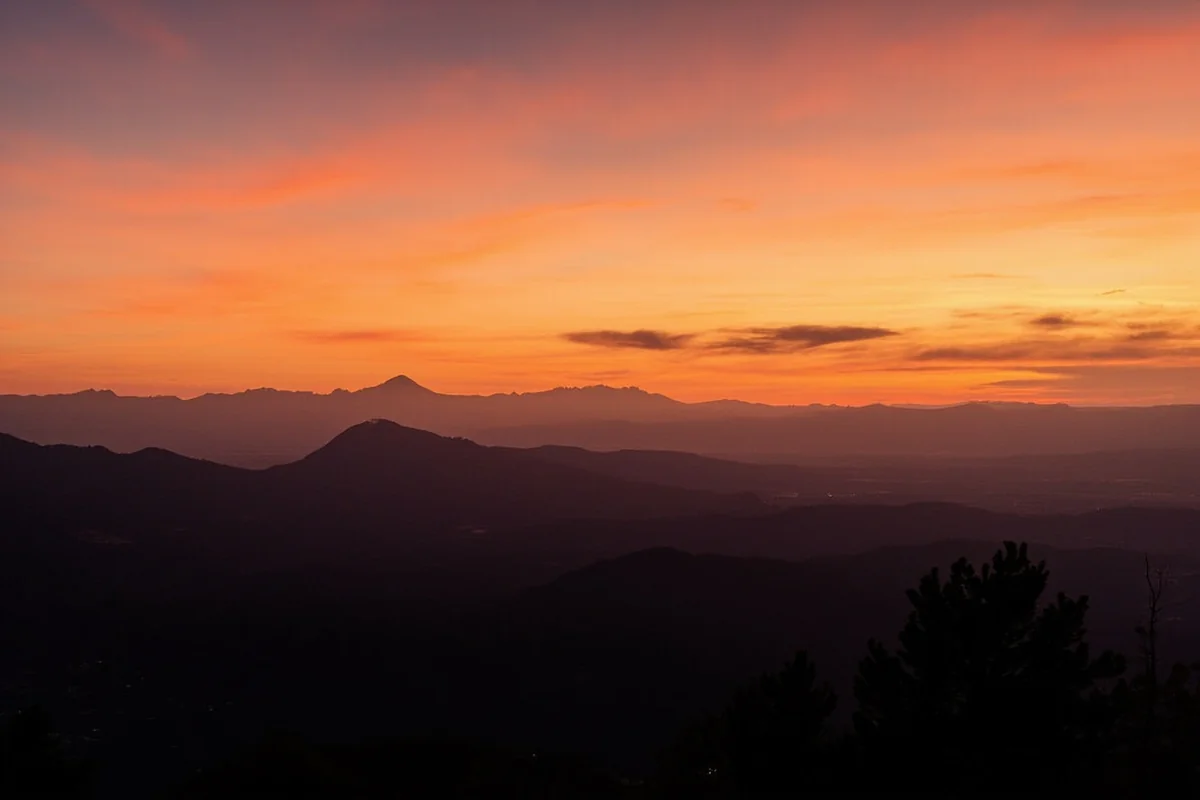 Sunset over Montana landscape with silhouetted mountains and wide open sky