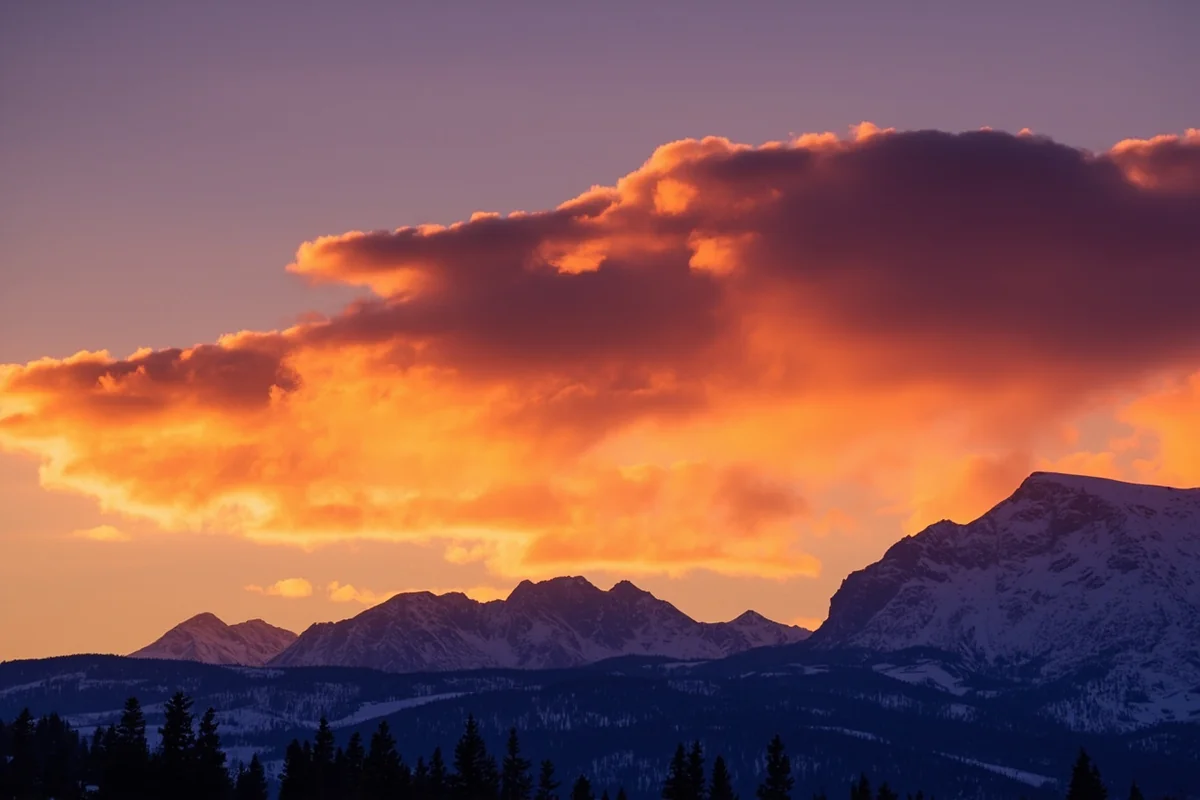 Sunset over Montana mountains with dramatic winter cloud formations