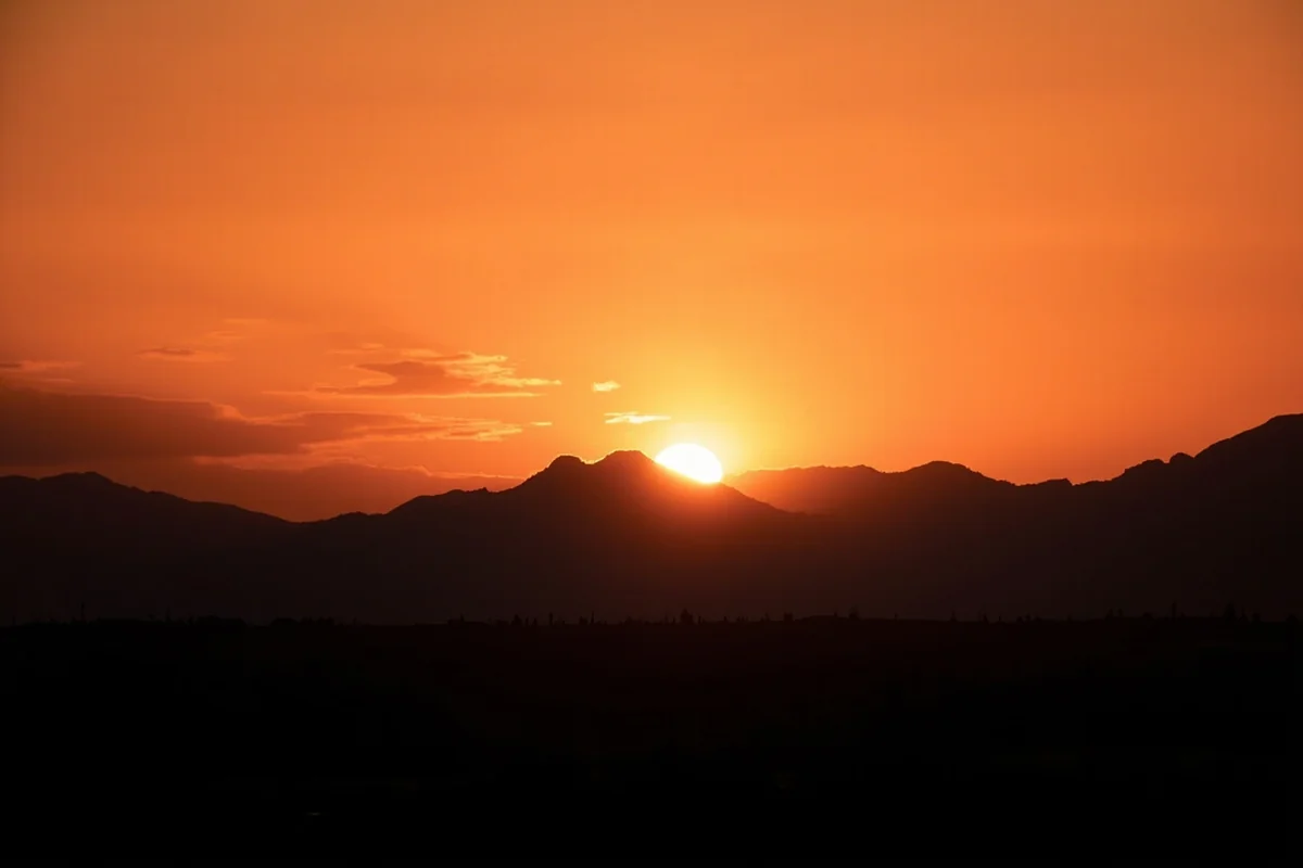 Sunset over Montana mountains with silhouette suggesting cinematic framing